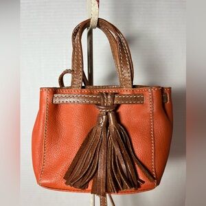 Clever Carriage Company orange mini tassel purse